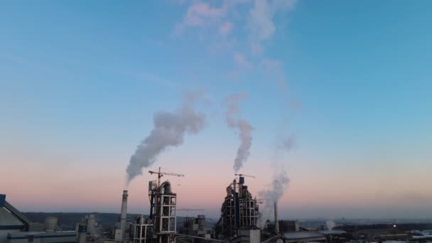 Flygfoto av cementfabrik med hög betongstruktur och tornkranar vid industriellt produktionsområde. Växthusgasrök förorenande atmosfär. Tillverkning och globalt industrikoncept. — Stockvideo