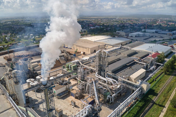 Aerial view of oil and gas refining petrochemical factory with high refinery plant manufacture structure. Global production and manufacturing concept