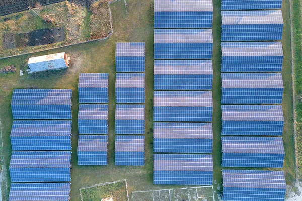 Vista aérea de una gran central eléctrica sostenible con filas de paneles fotovoltaicos solares para producir energía eléctrica ecológica limpia. Electricidad renovable con concepto de cero emisiones. — Foto de Stock