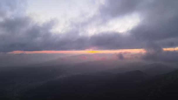 Aerial reveal shot from above at high altitude of dense puffy cumulus clouds flying in evening. Amazing sunset from airplane window point of view — Stock Video