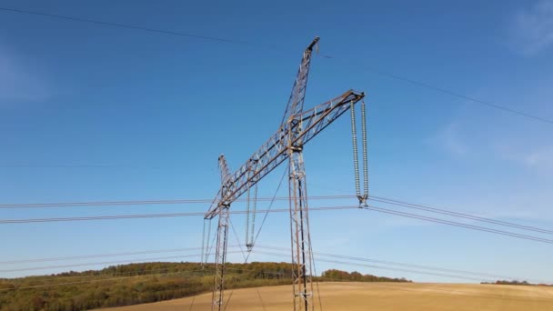 Steel pillar with high voltage electric power lines delivering electrical energy through cable wires on long distance — Stock Video