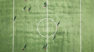 Yeşil spor stadyumunda futbol oynayan futbolcuların hava manzarası