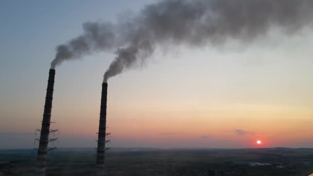 Aerial view of coal power plant high pipes with black smoke moving upwards polluting atmosphere at sunset. Production of electrical energy with fossil fuel concept — Stockvideo