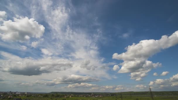 Time lapse footage of fast moving white puffy clouds on blue clear sky — Stock Video