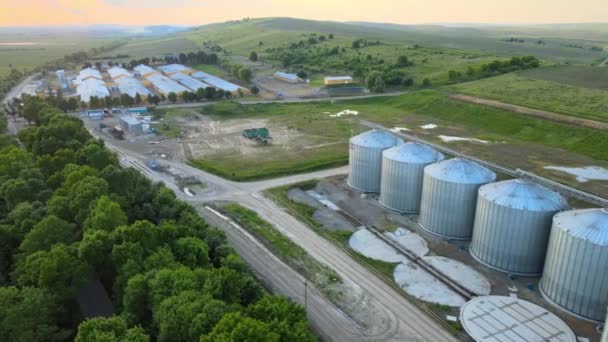 Aerial view of industrial ventilated silos for long term storage of grain and oilseed. Metal elevator for wheat drying in agricultural zone — Stock Video