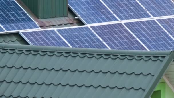 Casa residenziale con tetto coperto con pannelli fotovoltaici solari per la produzione di energia elettrica ecologica pulita in zona rurale suburbana. Concetto di casa autonoma — Video Stock