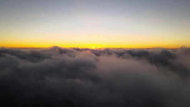 Aerial view from above at high altitude of dense puffy cumulus clouds flying in evening. Amazing sunset from airplane window point of view — 图库视频影像