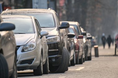 Sokak kenarında park halindeki arabalarla şehir trafiği