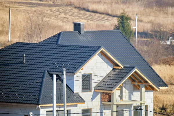 Cheminée sur le toit de la maison couverte de bardeaux métalliques en construction. Revêtement carrelé du bâtiment. Développement immobilier — Photo