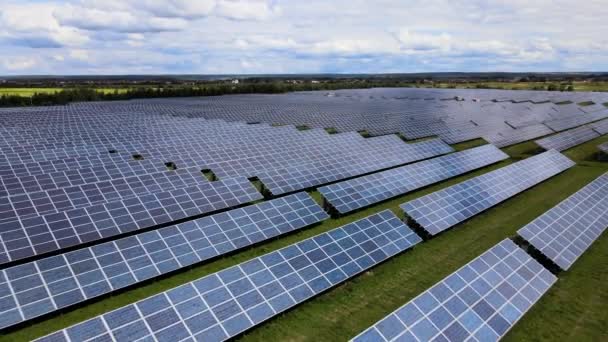 Letecký pohled na velkou udržitelnou elektrárnu s řadami solárních fotovoltaických panelů pro výrobu čisté elektrické energie. Koncepce elektřiny z obnovitelných zdrojů s nulovými emisemi — Stock video