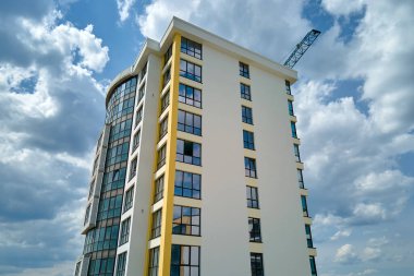 Birçok pencere ve balkonu olan modern yüksek apartman cephesinin mimari ayrıntıları