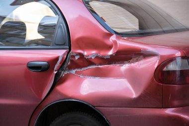 Şehrin caddesine park edilmiş hasarlı bir araba. Yol güvenliği ve araç sigortası kavramı