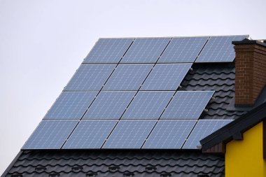 Şehrin kırsal kesimlerinde temiz ekolojik elektrik enerjisi üretmek için güneş fotovoltaik panellerle kaplı özel bir çatı. Özerk ev kavramı