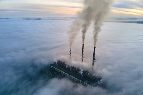 Vista aérea de tubulações altas da usina de carvão com fumaça preta que se move acima da atmosfera poluente no por do sol — Fotografia de Stock