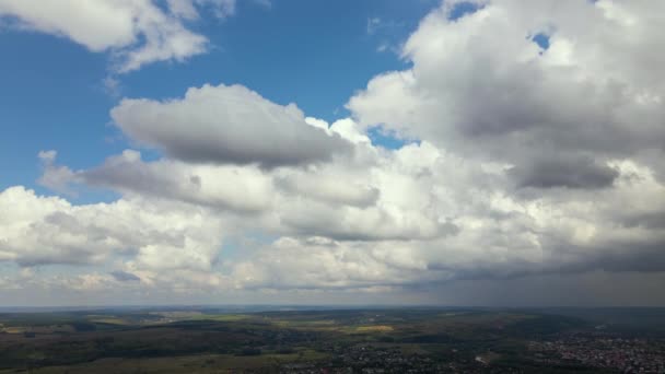 Aerial view from high altitude of distant city covered with puffy cumulus clouds forming before rainstorm — Stock Video