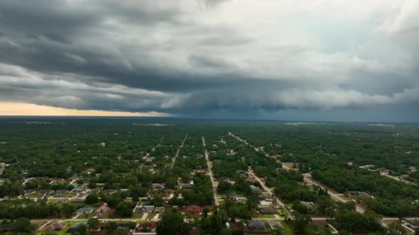 Dark stormy clouds forming on gloomy sky before heavy rainfall over suburban town area — Wideo stockowe