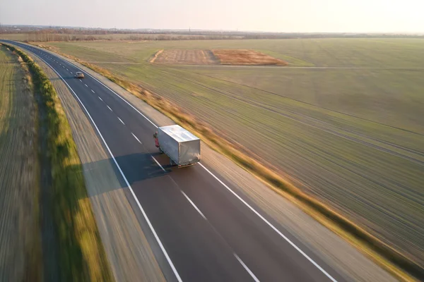 Aerial view of cargo truck driving on highway hauling goods. Delivery transportation and logistics concept — Stock Photo, Image