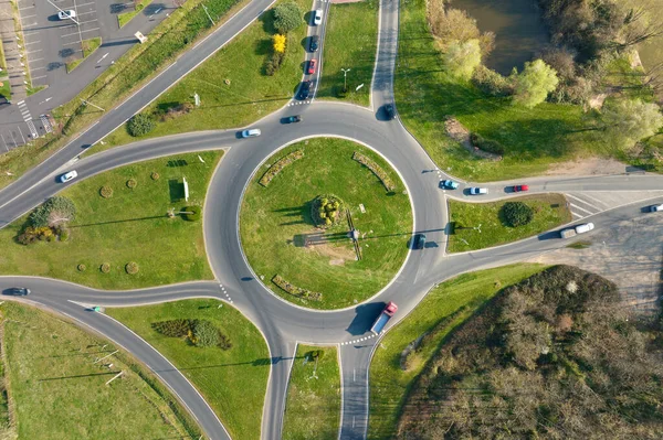 Aerial view of road roundabout intersection with moving heavy traffic. Urban circular transportation crossroads — Stockfoto