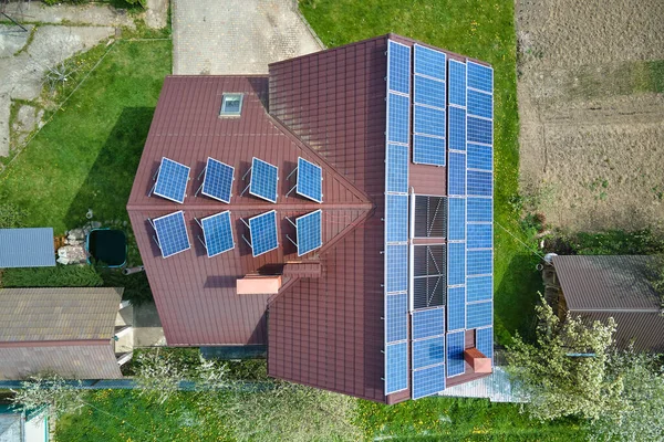 Private home roof covered with solar photovoltaic panels for generating of clean ecological electric energy in suburban rural town area. Concept of autonomous house