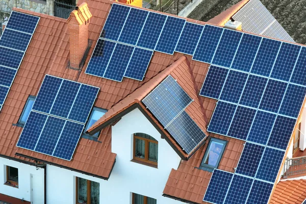 Residential house with rooftop covered with solar photovoltaic panels for producing of clean ecological electrical energy in suburban rural area. Concept of autonomous home — Stock Photo, Image