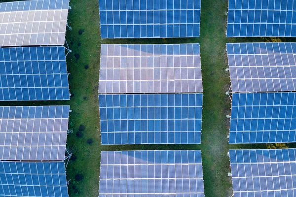 Vista aerea di grande centrale elettrica sostenibile con filari di pannelli fotovoltaici solari per la produzione di energia elettrica ecologica pulita. Elettricità rinnovabile a emissioni zero. — Foto Stock