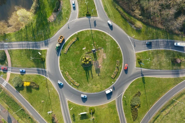 Aerial view of road roundabout intersection with moving heavy traffic. Urban circular transportation crossroads — Stockfoto