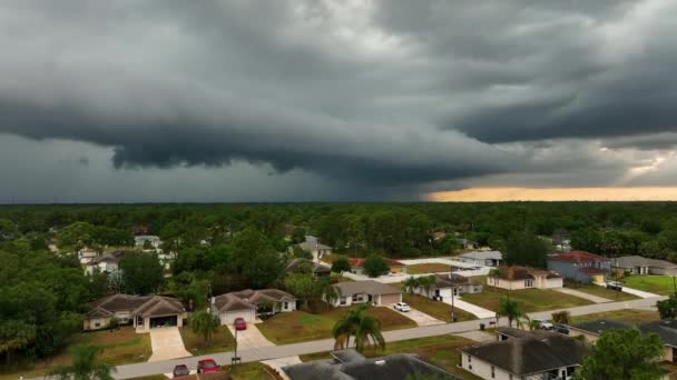 Dark stormy clouds forming on gloomy sky before heavy rainfall over suburban town area — Wideo stockowe