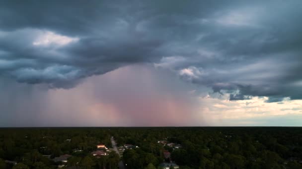 Dark stormy clouds forming on gloomy sky before heavy rainfall over suburban town area — ストック動画