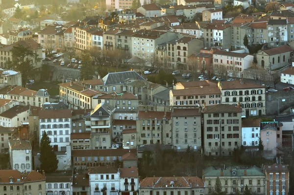 Aerial view of dense historic center of Thiers town in Puy-de-Dome department, Auvergne-Rhone-Alpes region in France. Rooftops of old buildings and narrow streets at sunset — Stock Photo, Image