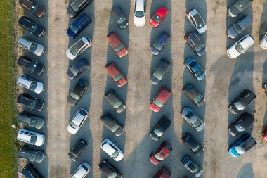 Aerial view of many colorful cars parked on dealer parking lot for sale