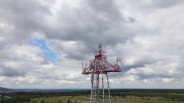 Aerial view of telecommunications cell phone tower with wireless communication antennas for network signal transmission