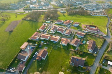 Aerial view of residential houses in green suburban rural area.