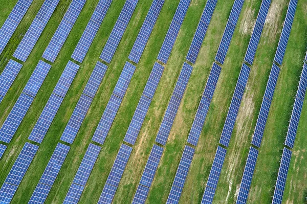 きれいな生態系の電気エネルギーを生成するための太陽光発電パネルの多くの行を持つ大規模な持続可能な電気発電所の空中ビュー 排出ゼロをコンセプトとした再生可能エネルギー — ストック写真