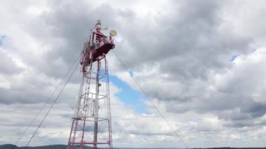 Aerial view of telecommunications cell phone tower with wireless communication antennas for network signal transmission.