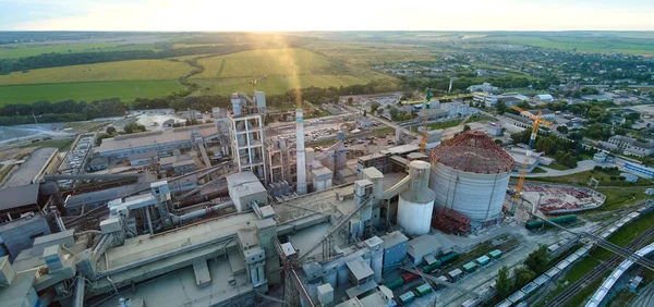 Aerial view of cement factory tower with high concrete plant structure at industrial production area. Manufacturing and global industry concept.