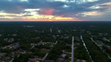 Banliyö manzarası. Akşamları Florida 'nın sakin bölgesinde yeşil palmiye ağaçları arasında özel evler var..