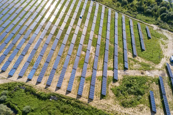Yeşil alandaki güneş enerjisi santralinin havadan görüntüsü. Temiz ekolojik enerji üretmek için panelleri olan elektrik çiftliği.