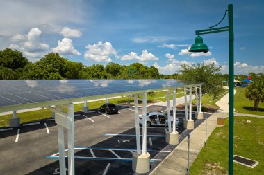Solar panels installed over parking lot for parked cars for effective generation of clean energy.