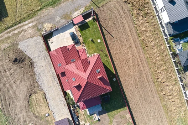 Aerial view of residential house with backyard in suburban rural area.