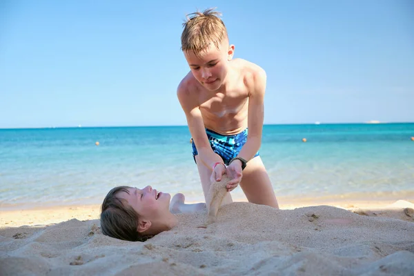 Two Kids Play Beach Laughing Boy Covers Smiling Girl White — 스톡 사진
