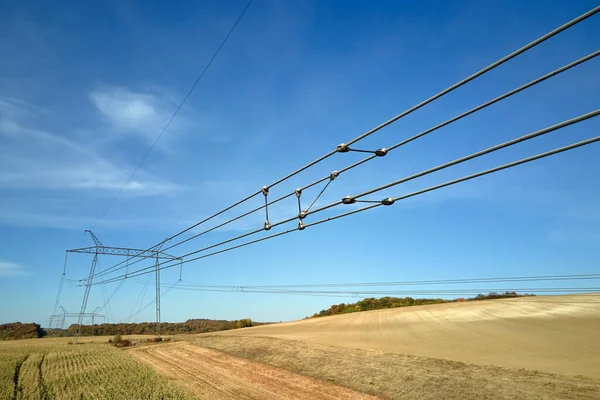 Electric power lines divided by safe guard insulating frame transfening safely high voltage electrical energy through cable wires. Electricity transmission on long distance concept.