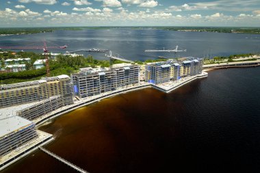 Tower lifting cranes at high residential apartment buildings construction site. Real estate development.