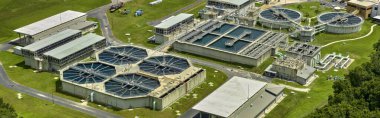 Aerial view of modern water cleaning facility at urban wastewater treatment plant. Purification process of removing undesirable chemicals, suspended solids and gases from contaminated liquid.