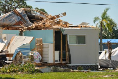 Badly damaged mobile home after hurricane Ian in Florida residential area. Consequences of natural disaster. clipart