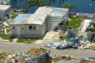 Destroyed by hurricane Ian suburban house in Florida mobile home residential area. Consequences of natural disaster. clipart