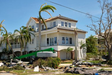 Destroyed by hurricane Ian expensive house in Florida residential area. Consequences of natural disaster. clipart