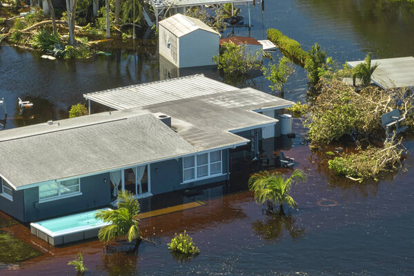 Flooded house by hurricane Ian rainfall in Florida residential area. Consequences of natural disaster.