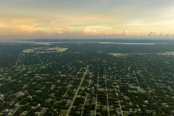 落日时分佛罗里达宁静的农村地区绿树之间的郊区民房空中景致 — 图库照片