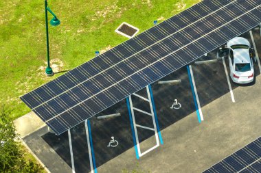 Solar panels installed over parking lot for parked cars for effective generation of clean energy.