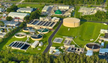 Aerial view of modern water cleaning facility at urban wastewater treatment plant. Purification process of removing undesirable chemicals, suspended solids and gases from contaminated liquid.